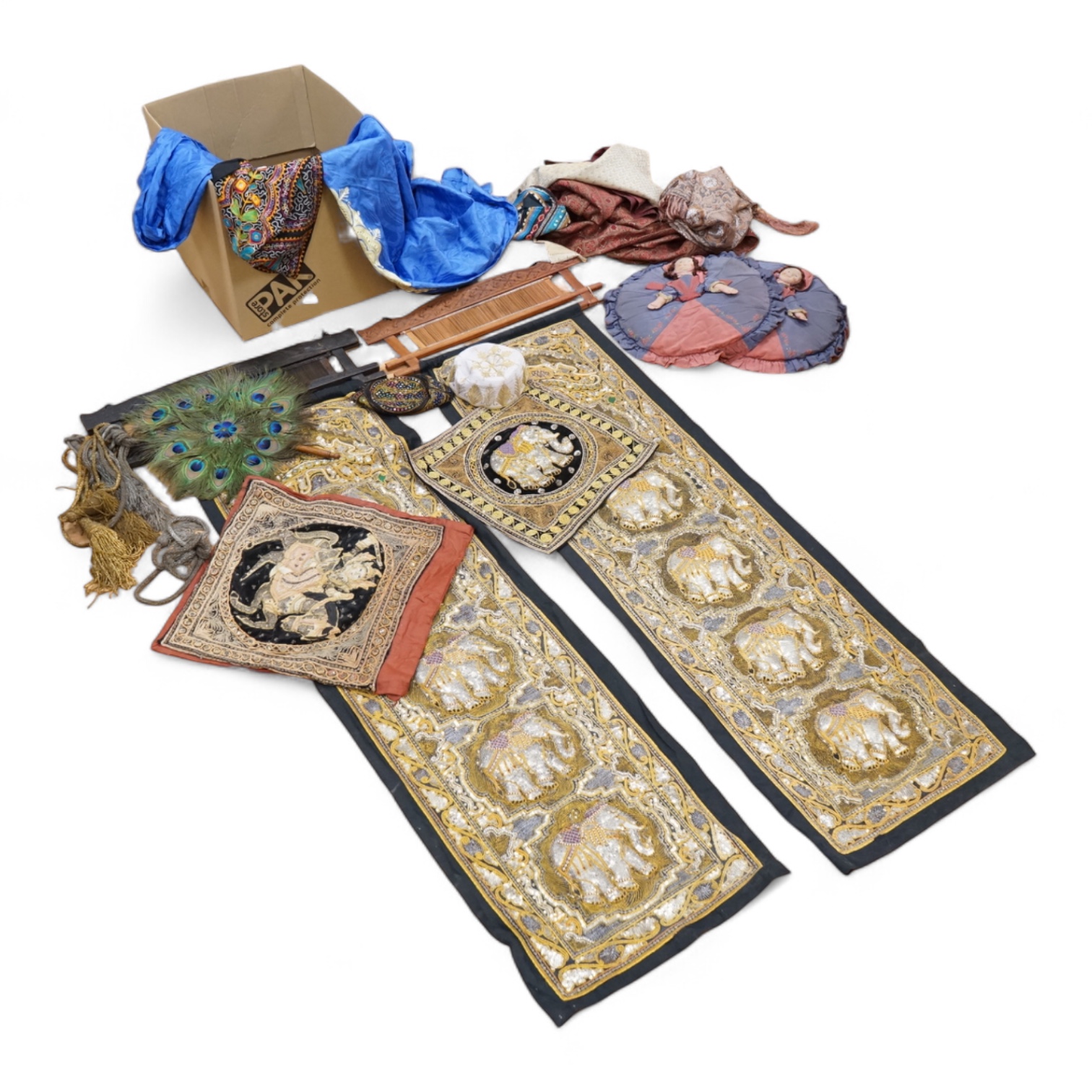 A quantity of mostly 20th century Middle Eastern and Indian woven and printed textiles and a peacock feather fan (2 boxes).
